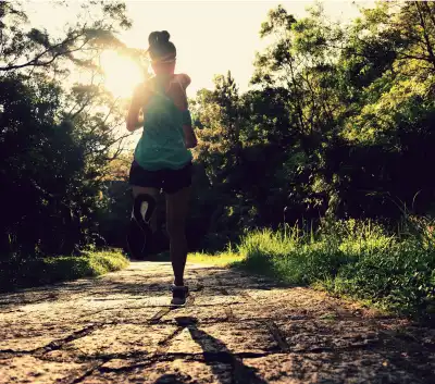 runner-athlete-running-on-forest-trail-woman